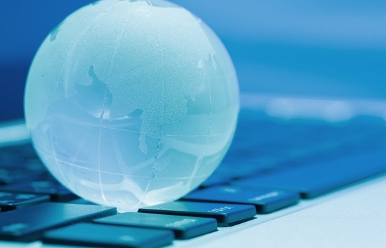 a glass globe on a laptop keyboard