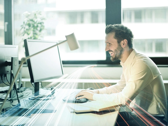 happy man in front of a computer