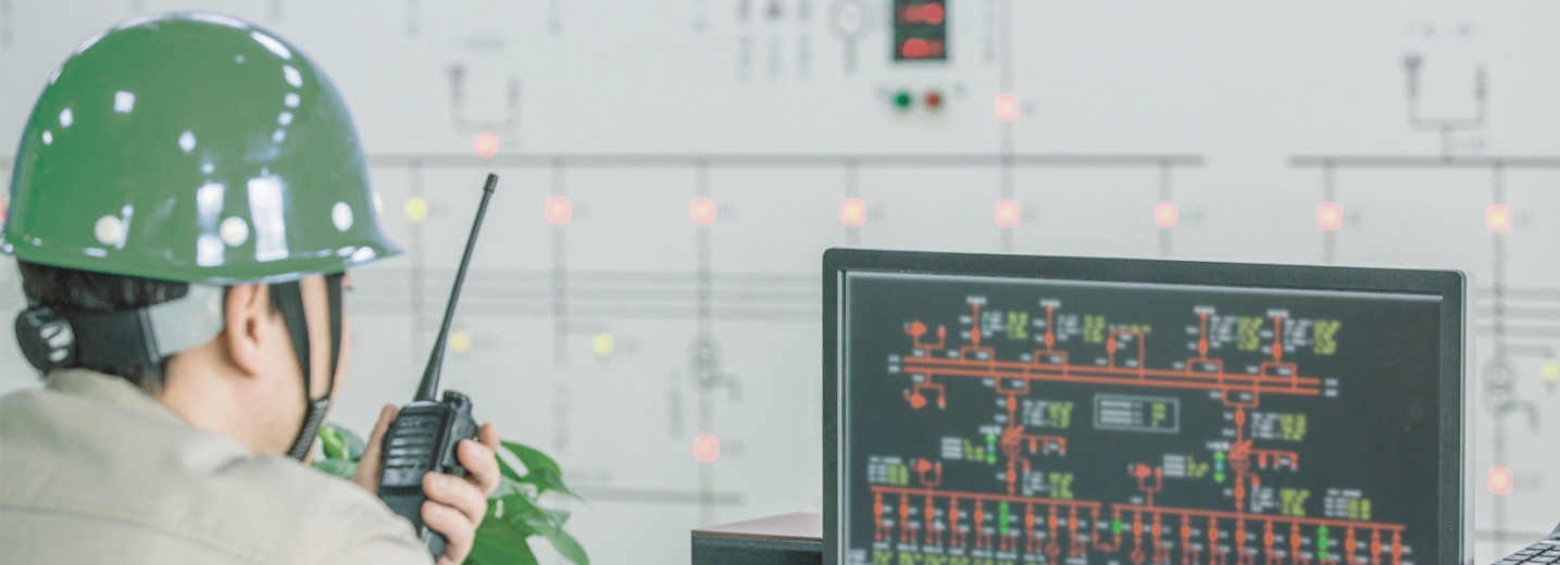 a man with a walkie talkie monitoring a screen