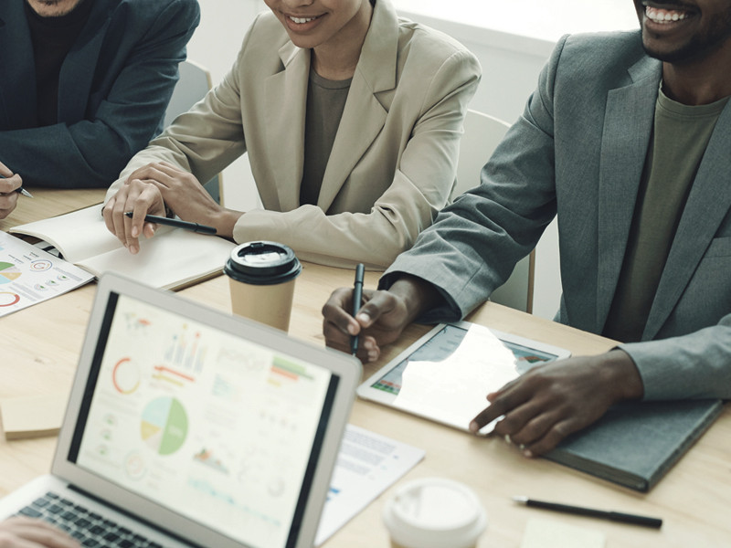 people sitting at a conference table with smiles on their faces